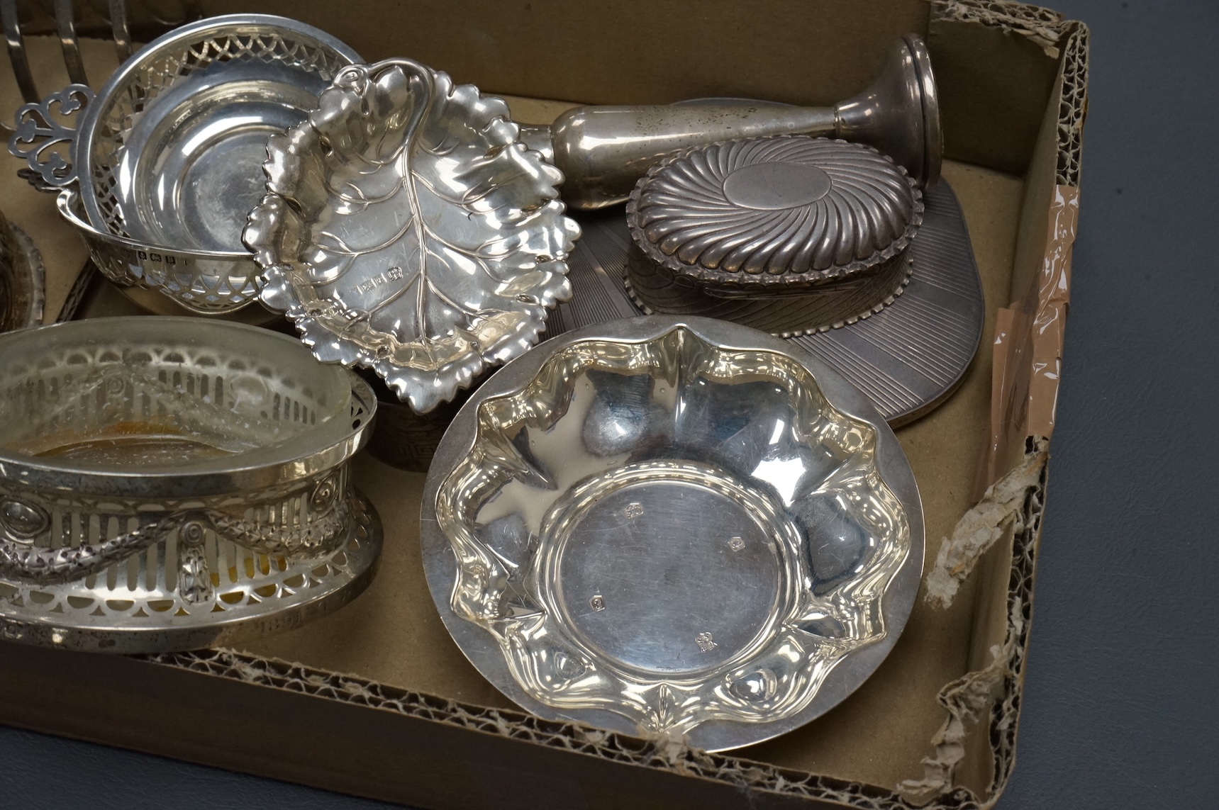 A group of small collectable silver including a late Victorian heart shaped trinket box, Chester, 1899, length 92mm (a.f.), a coaster, toast rack, spill vase, small trinket box, a pair of two handled dishes, napkin ring,